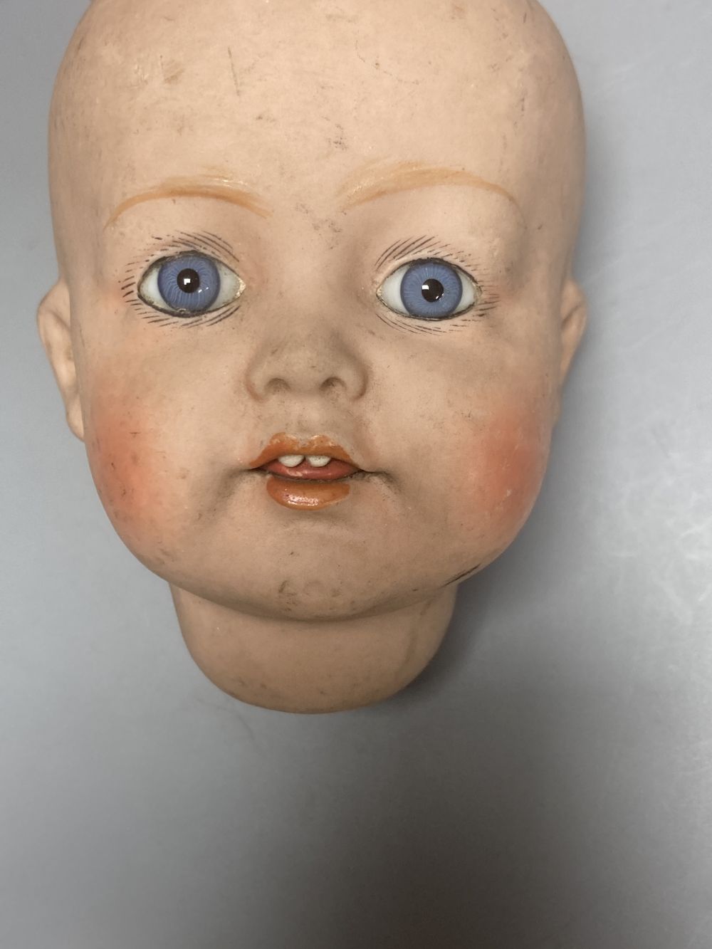 A Kammer & Reinhardt / Simon & Halbig bisque doll head, 10cm, three other German bisque doll heads and two English bisque doll heads,